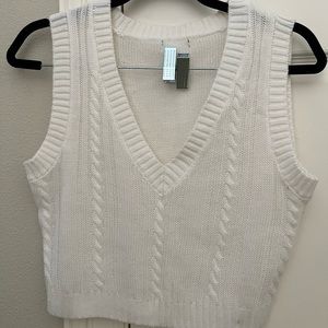 Cream colored ; sweater vest!